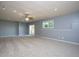 Finished basement with neutral walls, carpet, recessed lights and a walkout at 2725 Gross Ave, Wake Forest, NC 27587