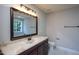 Bathroom vanity with marble countertop, a large mirror and traditional fixtures at 2725 Gross Ave, Wake Forest, NC 27587