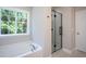 Modern bathroom with a soaking tub, a black framed glass shower and a bright window view at 2725 Gross Ave, Wake Forest, NC 27587