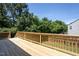 Sunny wooden deck provides views of the surrounding fenced backyard and lush greenery at 2725 Gross Ave, Wake Forest, NC 27587