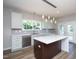 Updated kitchen with stainless dishwasher, modern lighting, and backyard view at 2725 Gross Ave, Wake Forest, NC 27587