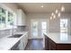 Stylish kitchen featuring sleek countertops, ample natural light, and backyard access at 2725 Gross Ave, Wake Forest, NC 27587