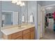 Bathroom featuring a vanity with a sink, a walk-in closet, and a neutral color palette at 2941 Grandview Heights Lane Ln, Raleigh, NC 27614