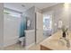 Bright bathroom featuring a shower-tub combo, double vanity, and an open doorway to a bedroom at 2941 Grandview Heights Lane Ln, Raleigh, NC 27614