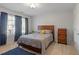 Neutral-toned bedroom featuring a cozy bed, a dark wood dresser, carpet, and plenty of natural light at 2941 Grandview Heights Lane Ln, Raleigh, NC 27614