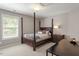Bedroom featuring a large window, a four poster bed with neutral colored bedding, and dark wood furniture at 2941 Grandview Heights Lane Ln, Raleigh, NC 27614