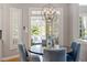 Inviting dining area with a modern chandelier and views of the outdoor space at 2941 Grandview Heights Lane Ln, Raleigh, NC 27614