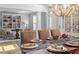 Open dining room with hardwood floors, chandelier lighting, and views into the living room with built-in features at 2941 Grandview Heights Lane Ln, Raleigh, NC 27614