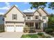 Charming two-story home featuring a stone and siding exterior, a two-car garage, and beautifully landscaped front yard at 2941 Grandview Heights Lane Ln, Raleigh, NC 27614
