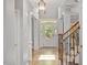 Bright and airy foyer featuring hardwood floors, elegant columns, and a staircase with wood railings at 2941 Grandview Heights Lane Ln, Raleigh, NC 27614