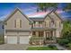 Charming two-story home with stone accents, a covered front porch, and a two-car garage at 2941 Grandview Heights Lane Ln, Raleigh, NC 27614
