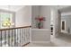 Hallway features a decorative railing, a corner table with flowers, and access to other rooms at 2941 Grandview Heights Lane Ln, Raleigh, NC 27614