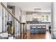 Bright, open kitchen with a blue island, modern lighting, white cabinets, stainless steel appliances, and hardwood floors at 2941 Grandview Heights Lane Ln, Raleigh, NC 27614