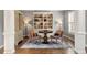 Stylish living room with hardwood floors, custom built-in bookcase, and comfortable seating area with accent pillows at 2941 Grandview Heights Lane Ln, Raleigh, NC 27614