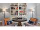Cozy living room featuring a round table, accent chairs, hardwood floors, and a custom built-in bookcase at 2941 Grandview Heights Lane Ln, Raleigh, NC 27614