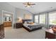 Spacious main bedroom with a ceiling fan, carpet, and plenty of natural light from multiple windows at 2941 Grandview Heights Lane Ln, Raleigh, NC 27614
