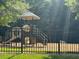Community playground featuring climbing structures, slides, and safe play areas, all within a fenced enclosure at 2941 Grandview Heights Lane Ln, Raleigh, NC 27614