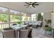 Inviting screened porch features stylish furniture, a ceiling fan, and views of the landscaped yard at 2941 Grandview Heights Lane Ln, Raleigh, NC 27614