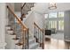 Grand staircase with wooden handrails, wrought iron spindles, and plush carpeting at 2941 Grandview Heights Lane Ln, Raleigh, NC 27614