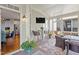 Enclosed sunroom with wicker furniture, plants, and a TV, connected to the kitchen at 2941 Grandview Heights Lane Ln, Raleigh, NC 27614