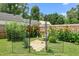 Lush backyard garden featuring decorative archway, colorful flower beds, and a serene seating area at 302 Bradley St, Burlington, NC 27215