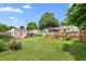 Expansive backyard featuring well-maintained lawn, shed, and fenced boundary for outdoor enjoyment at 302 Bradley St, Burlington, NC 27215