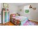 Cozy bedroom with hardwood floors, closet and bright floral bedding at 302 Bradley St, Burlington, NC 27215