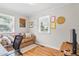 Bedroom with hardwood floors, a leather couch and an office desk with a rolling office chair at 302 Bradley St, Burlington, NC 27215