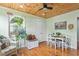Charming breakfast nook with wood ceiling and floors, featuring a window seat and table with chairs at 302 Bradley St, Burlington, NC 27215