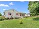 Quaint home featuring pink shutters and a well-maintained front lawn on a sunny day at 302 Bradley St, Burlington, NC 27215