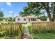 Charming home with pink shutters and a well-manicured lawn with a wooden fence at 302 Bradley St, Burlington, NC 27215