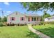 Charming home with pink shutters and a well-manicured lawn creates an inviting curb appeal at 302 Bradley St, Burlington, NC 27215
