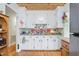 Bright white kitchen with matching cabinets and hardwood floors, featuring a breakfast bar at 302 Bradley St, Burlington, NC 27215