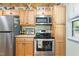 This stylish kitchen features stainless steel appliances and wood cabinets at 302 Bradley St, Burlington, NC 27215