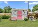 Quirky shed with pink door and flower boxes offering garden storage space with creative flair at 302 Bradley St, Burlington, NC 27215