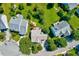 An aerial view displays the home nestled in a neighborhood with lush greenery and well-maintained streets at 3217 Enchanting Way, Raleigh, NC 27616