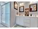 Bright bathroom featuring a glass door shower, double vanity, and neutral wall color at 3217 Enchanting Way, Raleigh, NC 27616