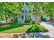 Beautiful two-story home featuring mature trees, a lush lawn, and a welcoming front porch at 3217 Enchanting Way, Raleigh, NC 27616
