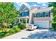 Inviting two-story home featuring a charming front porch, green shutters, and manicured landscaping at 3217 Enchanting Way, Raleigh, NC 27616