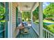 Relaxing covered front porch featuring comfortable seating, classic railings, and views of the well-manicured landscape at 3217 Enchanting Way, Raleigh, NC 27616