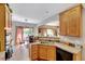 Well-maintained kitchen with wooden cabinetry, stainless appliances, and an adjacent eat-in area filled with sunlight at 3217 Enchanting Way, Raleigh, NC 27616