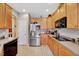Modern kitchen featuring stainless steel appliances, ample counter space, and lots of wooden cabinet storage space at 3217 Enchanting Way, Raleigh, NC 27616