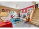 Well-lit living room with a fireplace, staircase and large windows that offer natural light at 3217 Enchanting Way, Raleigh, NC 27616