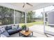 Screened-in porch with comfortable seating and views of the wooded backyard at 331 Bridle Brook Way, Fuquay Varina, NC 27526