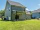 View of backyard with patio, siding and large green lawn area at 335 Glenn St, Franklinton, NC 27525