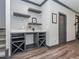 Stylish bar area with grey cabinets, white countertop, wine rack, and wood plank wall at 335 Glenn St, Franklinton, NC 27525