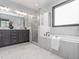 Luxury bathroom featuring a soaking tub, walk-in shower, and double vanity at 335 Glenn St, Franklinton, NC 27525
