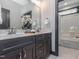 Bathroom with a double sink vanity, a large mirror, and a view of the shower and tub at 335 Glenn St, Franklinton, NC 27525