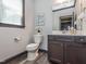 Powder room featuring a decorative mirror, new toilet, and vanity with storage at 335 Glenn St, Franklinton, NC 27525