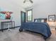 Cozy bedroom with plush carpeting, a ceiling fan, and a comfortable bed with blue accents at 335 Glenn St, Franklinton, NC 27525